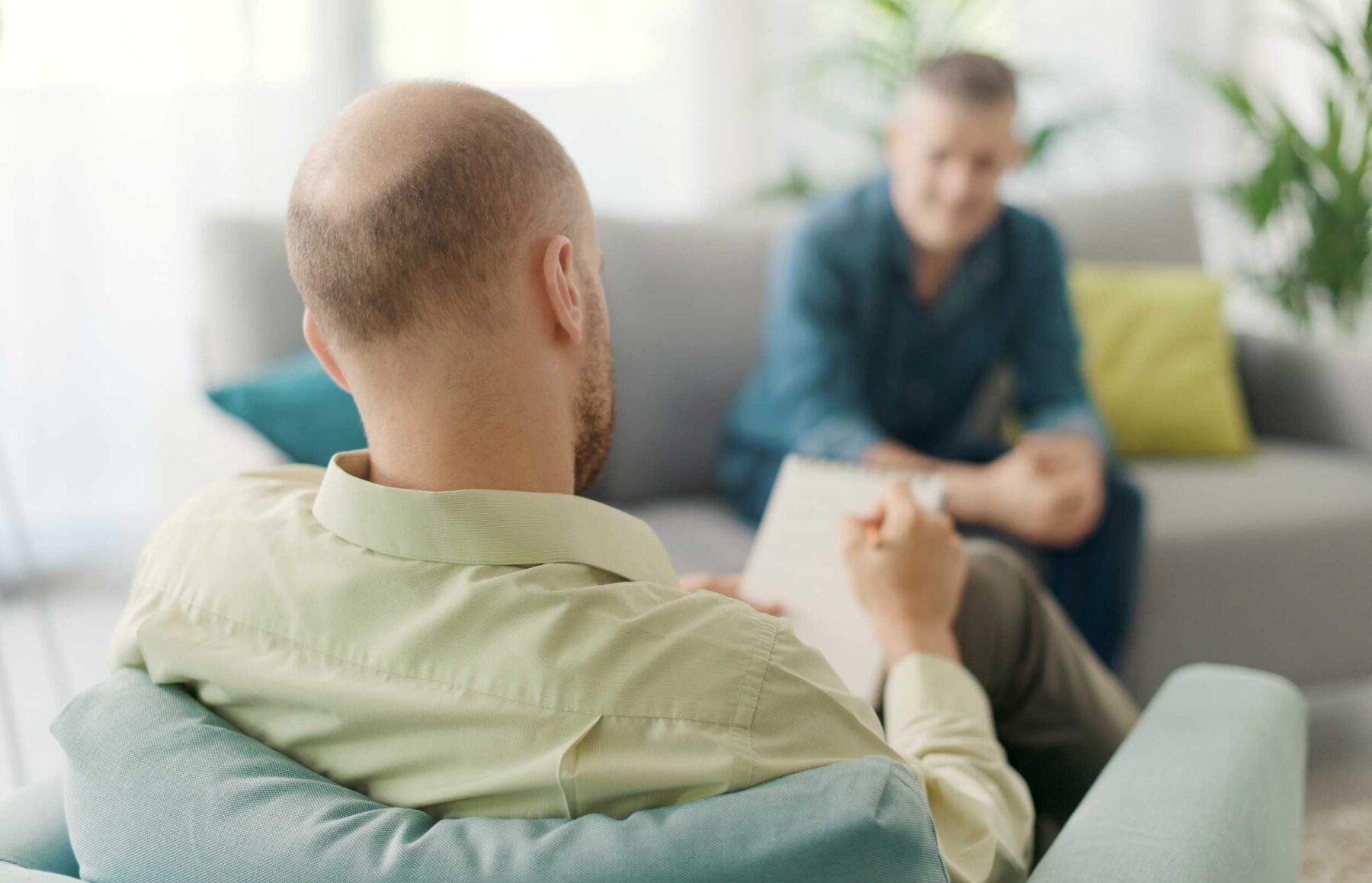 A man in therapy, speaking to a male therapist